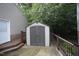 Backyard shed with gray double doors and railing at 116 Trinity Woods Dr, Raleigh, NC 27607