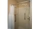 Walk-in shower stall with built-in shelving and grab bars at 116 Trinity Woods Dr, Raleigh, NC 27607