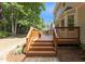 The backyard features a wooden deck with steps down to a landscaped lawn at 1210 Eastham Dr, Apex, NC 27502