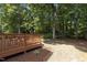 Wooden deck with outdoor seating overlooks a landscaped lawn and wooded area at 1210 Eastham Dr, Apex, NC 27502