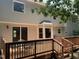 Spacious wooden deck perfect for outdoor entertaining, featuring glass doors and views of the backyard at 1210 Eastham Dr, Apex, NC 27502