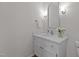 Bathroom vanity with white cabinet, marble countertop, sink, and mirror at 1210 Eastham Dr, Apex, NC 27502