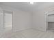 Neutral carpeted bedroom with two closets, and an open doorway creating a spacious, and light-filled atmosphere at 1210 Eastham Dr, Apex, NC 27502