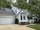 Charming two-story home with a two-car garage, manicured lawn, and traditional design elements at 1210 Eastham Dr, Apex, NC 27502