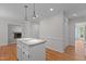 View of the kitchen island with granite countertop and view to the living room at 1210 Eastham Dr, Apex, NC 27502