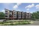 Modern apartment building with retail shops, street parking, and pedestrian-friendly walkways at 130 Two Hills Dr # 104B, Carrboro, NC 27510