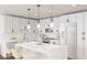 Bright kitchen featuring white cabinetry, marble countertops, and modern lighting fixtures at 130 Two Hills Dr # 205B, Carrboro, NC 27510