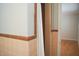 Bathroom showing peach tile, shower curtain, and entrance to additional room at 1307 Sycamore Dr, Garner, NC 27529