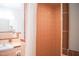 Bathroom shower with peach tile and hardware with additional vanity at 1307 Sycamore Dr, Garner, NC 27529