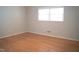Bedroom with hardwood floors and neutral paint, featuring a large window at 1307 Sycamore Dr, Garner, NC 27529