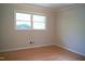This bedroom features hardwood floors and a bright window overlooking greenery at 1307 Sycamore Dr, Garner, NC 27529