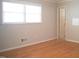 Bedroom with natural light, neutral paint, hardwood floors, and a doorway leading to the bathroom at 1307 Sycamore Dr, Garner, NC 27529
