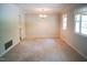 The carpeted Dining Room is naturally lit with a classic chandelier and elegant trim at 1307 Sycamore Dr, Garner, NC 27529