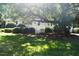 Charming home with a well-manicured lawn and mature landscaping, including a large shade tree at 1307 Sycamore Dr, Garner, NC 27529