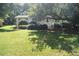 Quaint home with lush green lawn and manicured hedges, shaded by mature trees at 1307 Sycamore Dr, Garner, NC 27529