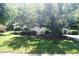 View of the property showing landscaping and the home's setting on the lot with mature tree at 1307 Sycamore Dr, Garner, NC 27529