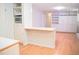 Open kitchen space with microwave and counter connecting to living room at 1307 Sycamore Dr, Garner, NC 27529