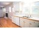 Bright and open kitchen with stainless steel sink and a view of a fireplace at 1307 Sycamore Dr, Garner, NC 27529