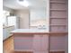 Kitchen view featuring a breakfast bar, white cabinets, and modern appliances at 1307 Sycamore Dr, Garner, NC 27529