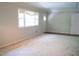 Spacious carpeted Living Room with crown molding is naturally lit and waiting for your personal touches at 1307 Sycamore Dr, Garner, NC 27529