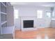 Cozy Living Room with wood floors, fireplace, and built-in shelving offers a warm atmosphere at 1307 Sycamore Dr, Garner, NC 27529