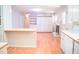 Open-concept kitchen flows into a living area with fireplace and plenty of storage in built-in cabinets at 1307 Sycamore Dr, Garner, NC 27529