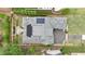 Aerial view of home showing landscaped yard, gray roof, brick water feature, and solar panels at 1312 Duplin Rd, Raleigh, NC 27607