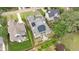 An aerial view shows the home with solar panels, a large yard, and surrounding neighborhood at 1312 Duplin Rd, Raleigh, NC 27607