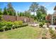 Backyard view of brick water feature, lush landscaping, and sitting areas on a sunny day at 1312 Duplin Rd, Raleigh, NC 27607