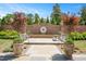 A brick water feature accents a serene backyard with mature trees and landscaping at 1312 Duplin Rd, Raleigh, NC 27607
