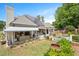Aerial angle of landscaped backyard with patio, water feature, and solar panels at 1312 Duplin Rd, Raleigh, NC 27607