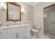 Elegant bathroom featuring a marble countertop vanity, decorative mirror, and a glass-enclosed shower at 1312 Duplin Rd, Raleigh, NC 27607