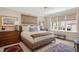 Bright bedroom showcasing a beautifully decorated bed, stylish furnishings, and lots of natural light from the large window at 1312 Duplin Rd, Raleigh, NC 27607