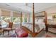 Inviting bedroom with four-poster bed, large windows offering scenic views, and cozy decor with a relaxed atmosphere at 1312 Duplin Rd, Raleigh, NC 27607