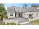 Stunning white brick home features a charming drive and attached two-car garage at 1312 Duplin Rd, Raleigh, NC 27607