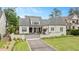 Elegant home showcasing a symmetrical facade, well-manicured lawn, and a classic white brick exterior at 1312 Duplin Rd, Raleigh, NC 27607