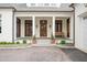 Inviting front porch with stately columns, wood doors, and bench at 1312 Duplin Rd, Raleigh, NC 27607