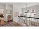 Bright hallway featuring crown molding, hardwood floors, decorative artwork, and a view into an adjacent room at 1312 Duplin Rd, Raleigh, NC 27607