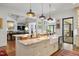 Open-concept kitchen with an island, breakfast bar, and a view into the living room at 1312 Duplin Rd, Raleigh, NC 27607