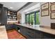 Custom butler's pantry featuring marble countertops, window views, and ample storage at 1312 Duplin Rd, Raleigh, NC 27607