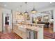 Open-concept kitchen with an island, breakfast bar, and a view into the living room at 1312 Duplin Rd, Raleigh, NC 27607