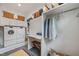 Well-equipped laundry room with Miele washer and dryer, folding station, storage cabinets, and stylish slate flooring at 1312 Duplin Rd, Raleigh, NC 27607