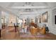 Bright open-plan living room featuring vaulted ceilings with exposed beams, built-in shelving, and a fireplace at 1312 Duplin Rd, Raleigh, NC 27607