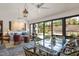 Inviting living room with ample seating, a glass dining table, and expansive windows overlooking the backyard at 1312 Duplin Rd, Raleigh, NC 27607