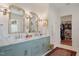 Luxurious main bathroom featuring a double vanity, elegant mirrors, and a spacious walk-in closet at 1312 Duplin Rd, Raleigh, NC 27607