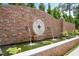 Close up of water feature with circular stone backdrop, fountain, and pond with water lilies at 1312 Duplin Rd, Raleigh, NC 27607