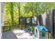 Back deck featuring a playhouse and mature trees at 1408 Bridgeport Dr, Raleigh, NC 27615