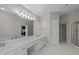 Spacious bathroom features a long vanity, large mirror, and separate shower at 1408 Bridgeport Dr, Raleigh, NC 27615
