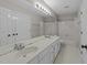 Spacious bathroom featuring a double vanity, shower-tub combo, and tile flooring at 1408 Bridgeport Dr, Raleigh, NC 27615