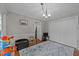 Bright bedroom with a patterned rug, neutral walls, and a decorative light fixture at 1408 Bridgeport Dr, Raleigh, NC 27615